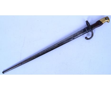 An 1881 pattern French rifle bayonet. Brass handle tip with wooden grips to the handle. Text to blade, with serial number to 