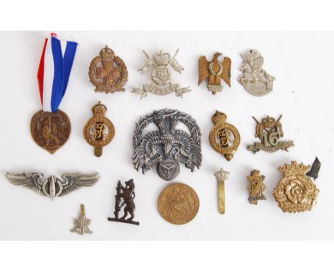A collection of assorted WWII and other cap badges to include; Duke Of Lancasters, The Queens Lancers, Life Guards and others