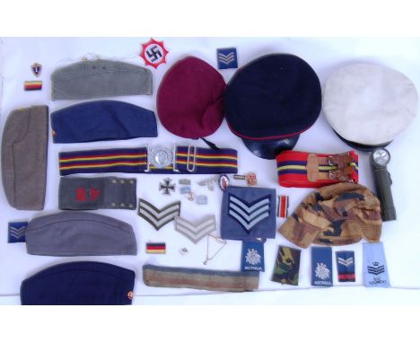 A collection of assorted militaria items to include; peaked caps, uniform hats, stripes, replica patches, reproduction Iron c