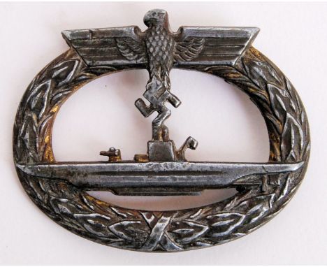 An original WWII Second World War Third Reich / Nazi German made U Boat uniform badge. Depicting a U Boat within a gilt laure