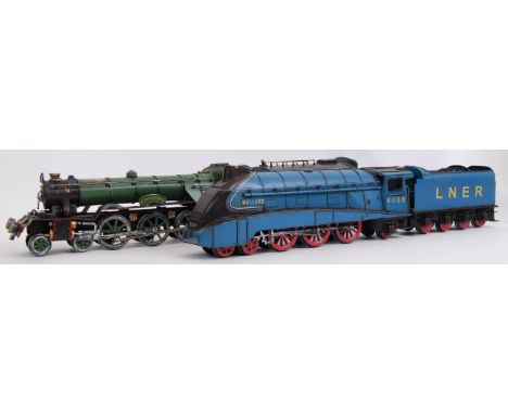 Two vintage style, 20th century tinplate steam trains with carriages. One is a Mallard and the other the Flying Scotsman. Bot