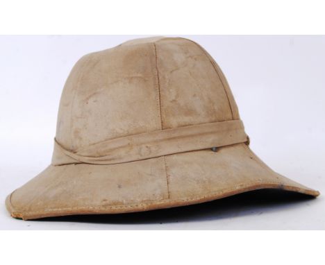 An original vintage wartime canvas covered pith helmet. Squared peak to reverse. With liner. POSTAGE: Worldwide postage / del