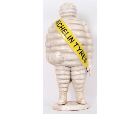A vintage style, 20th century cast iron figure of the Michelin man wearing a yellow sash with Michelin Tyres written on it. 5