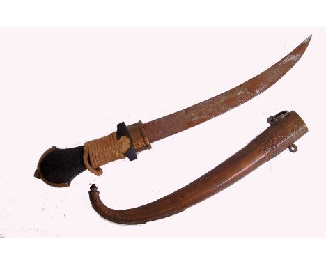 An early 20th century Indian ceremonial dagger with copper scabbard. Unmarked curved blade and wooden handle.  Approx 43cm lo