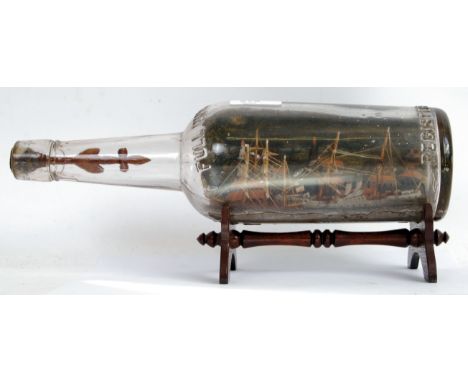 A vintage prisoner of war/ POW style model ship scene within a glass bottle on wooden stand.  POSTAGE: Worldwide postage / de