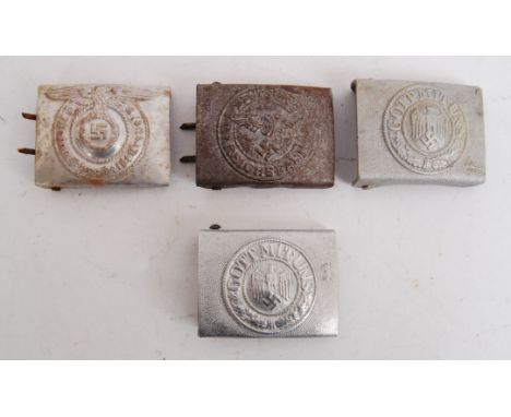 A collection of 4x Third Reich Nazi belt buckles. Each of white metal design, with a differing emblem to the front. One SS (b