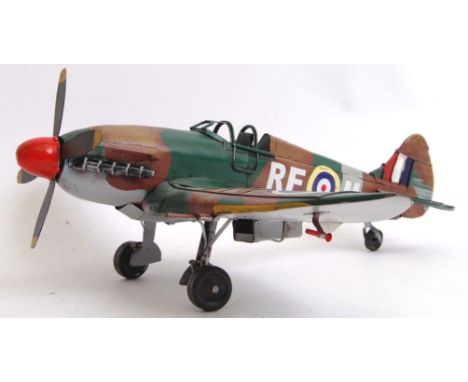 A vintage style, 20th century tinplate Spitfire. Measures 37cm long.  POSTAGE: Worldwide postage / delivery available on all 