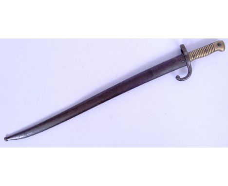 An original 20th century bayonet believed to be of German origin. Brass handle with scabbard. 9161.  POSTAGE: Worldwide posta