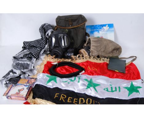 A collection of late 20th / early 21st century militaria to include a certificate of mobiliszation, map of Basra, a gas mask 
