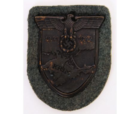 KRIM: An original German Krim 1941-42 shield / patch. Detailed to from ' Krim ' with date. POSTAGE: Worldwide postage / deliv
