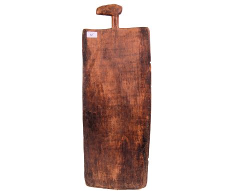 An early 20th century tribal paddle. faint writing to the front, all carved from the same piece of wood. 71cm tall.  POSTAGE: