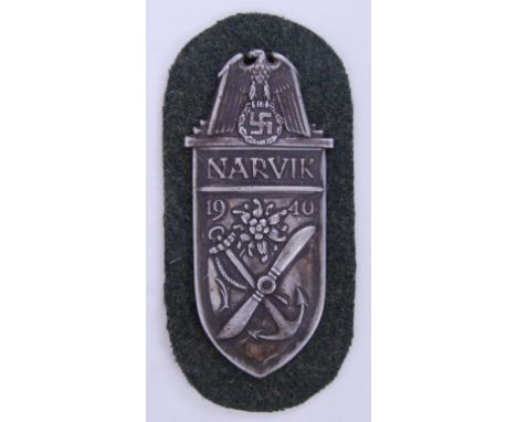 A WWII Second World War Third Reich ' Narvik ' shield medal / badge. Mounted on fabric patch. Dated 1940, decorated with a pr