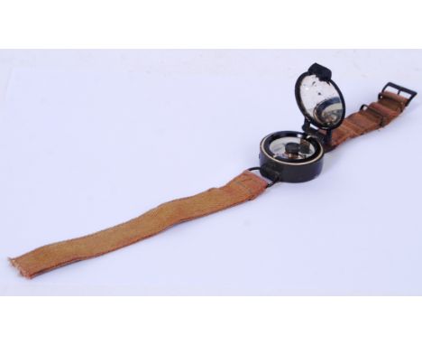 An original Second World War WWII pilots/ navigators compass watch. With original canvass strap and hinged top. The serial nu