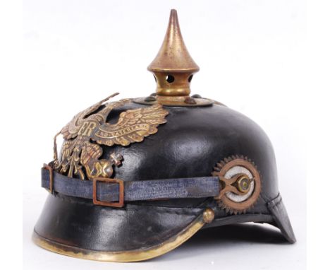 An original Imperial German Garde pickelhaube. Polished black leather skull, font and rear peaks; the front peak bound in bra