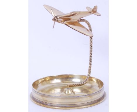 An impressive large sized WWI era large shell dated 1910, later made into a large ashtray with a model of a WWII Spitfire ato