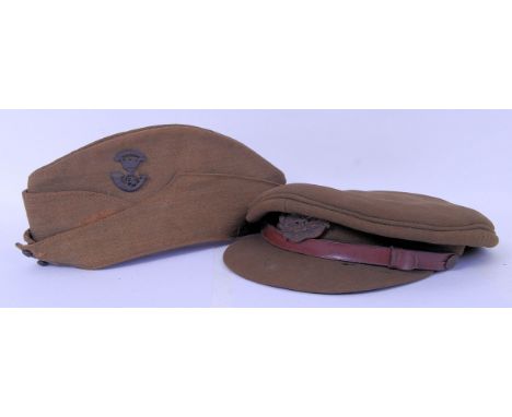 Two WWII Second World War era uniform hats to include an officers cap with Egypt badge, along with a forage cap with Jallabad
