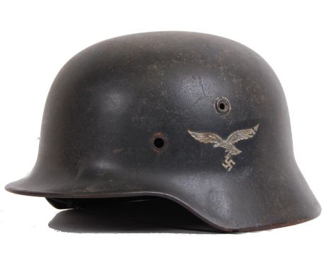 An original Third Reich Nazi WWII Second World War Luftwaffe tin helmet. With eagle to left side. No liner. Original. POSTAGE