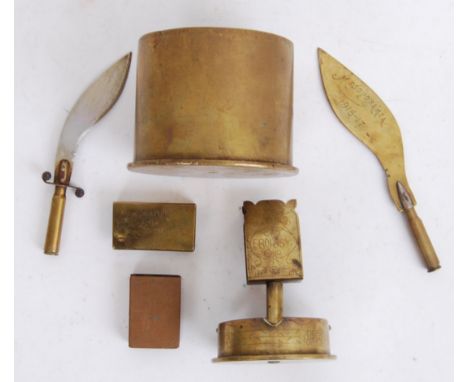 A collection of assorted First World War era trench art items to include; two letter openers, a larger shell ashtray, two mat