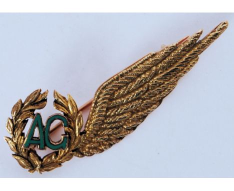 An original 9ct gold Air Gunners sweetheart brooch. With enamel AG to end, the gold brooch in the form of a single feathered 