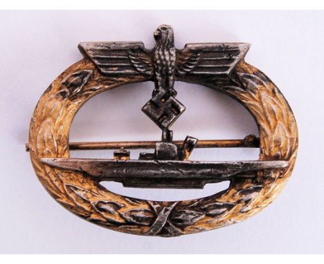 An original WWII Second World War Third Reich / Nazi German made U Boat uniform badge. Depicting a U Boat within a gilt laure