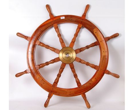 A Large Wooden Wheel for a ship with a Brass hub and 8 spokes, 42”/108cm in diameter. POSTAGE: Worldwide postage / delivery a