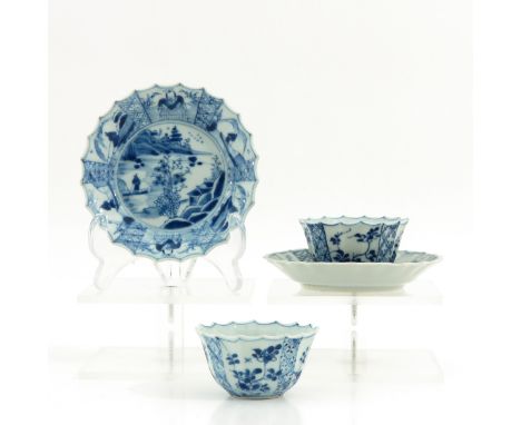 Blue and white decor depicting Chinese figures in landscape decor, saucers are 11 cm. in diameter, chip.