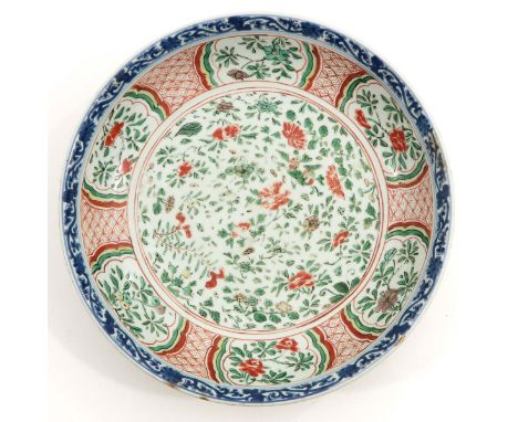 Decorated with flowers, Kangxi Mark and Period, 33 cm. in diameter, chip and hairline.