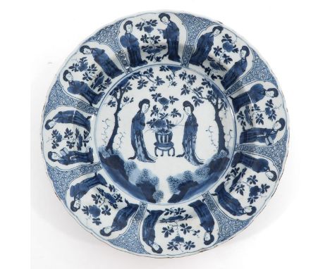 Depicting Chinese ladies in garden, Kangxi Mark and Period, 34 cm. in diameter, chip.