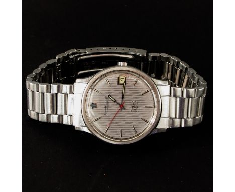 Electronic, with tuning fork, chronograph and date, steel band, case is 36 mm. in diameter.
