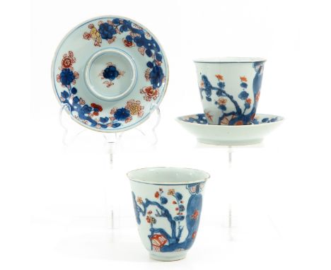 Floral decor in iron red, blue and gilt accents, 18th Century, with fitted saucers 13 cm. in diameter, chip and hairline.