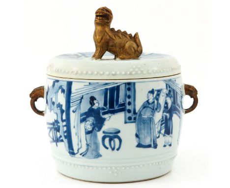 Depicting Chinese figures in garden, Kangxi Period, gold painted temple lion on cover, 21 cm. tall, cover is restored. 