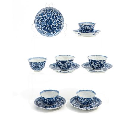 Blue and white floral decor, marked with conch shell, saucers are 12 cm. in diameter, 1 cup restored.