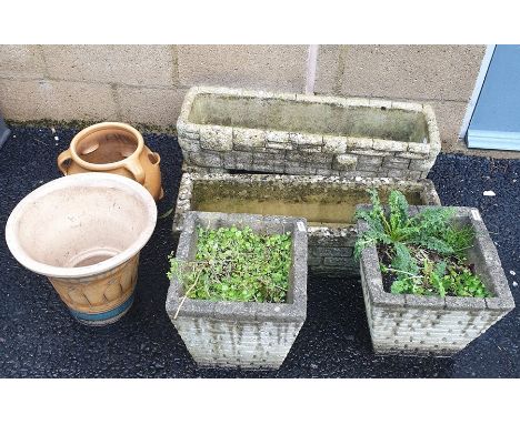 Two rectangular moulded concrete planters in the form of drystone walls, two tapered square planters, a ceramic strawberry/he