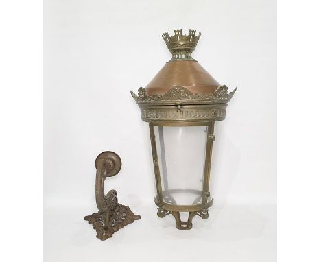 Copper, brass and glass lantern, the top castellated above a copper dome, cylindrical glass shade with iron wall mounter (bel