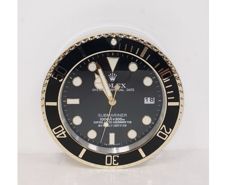 A Contemporary Rolex clock&nbsp;in the form of a submariner chronometer watch. Glows in the darkCondition ReportThe clock mea