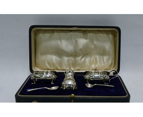 Silver condiment set of three pieces viz:- salt pot, mustard pot and pepperette, all raised on four feet, two various condime