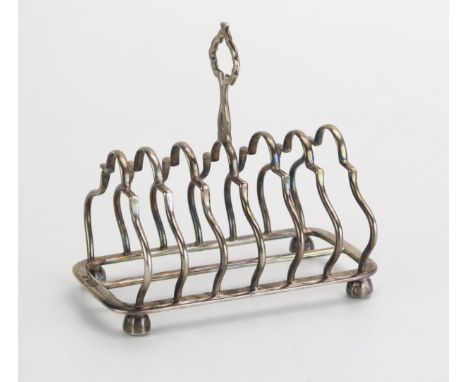 A George V silver six-division toast rack, maker William Hutton &amp; Sons Ltd, Sheffield, 1912, of arched outline raised on 