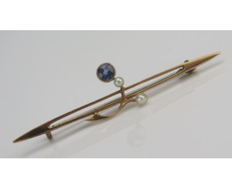 A Sapphire and Seed Pearl or Cultured Seed Pearl Bar Brooch in a precious yellow metal setting, c. 3.8mm millegrain set light