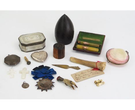 An early 19th century carved coconut , 10cm high, a mother-of-pearl rectangular snuff box, silver heart-shaped locket , two a