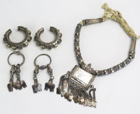 A middle eastern silver necklace with amulet box with chain suspensions, two silver amulets and a pair of large silver earrin