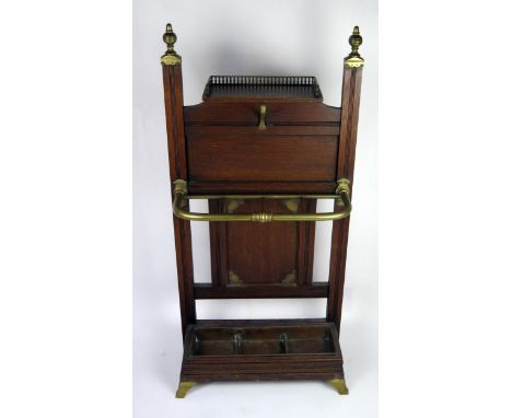 A Victorian Schoolbred style oak stick stand, the rectangular back with brass finials, with single short shelf, brass four - 