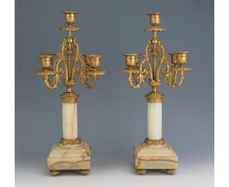 A pair of 19th century alabaster, marble and ormolu five light candelabra with urn-shaped sconces on four swept foliate branc