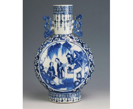 An 18th Century Chinese blue and white moon flask, of traditional design, the central panels decorated with figures in a gard