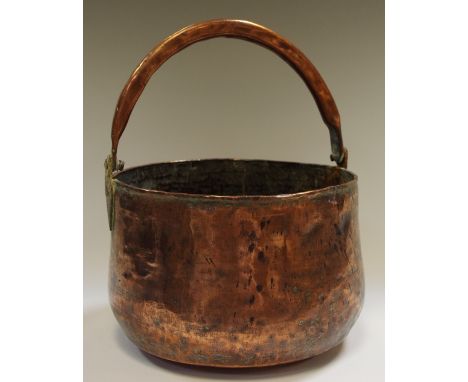 A 19th century planished copper jam pan with swing handle