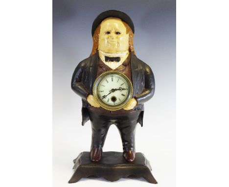 A reproduction  American type cast iron novelty mantel clock,  in the form of a standing rotund gentleman in top hat and tail