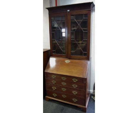 An early George III mahogany bureau bookcase, dentil cornice above a pair of astragal glazed doors, fall front enclosing a fi