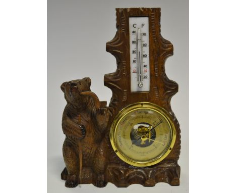 A Black Forest desk barometer and thermometer, carved with a bear smoking a pipe