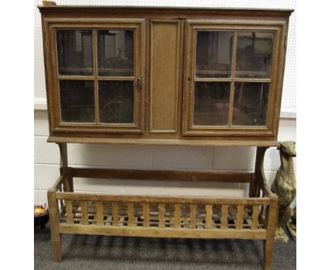 A French oak farmhouse dresser, two glazed doors enclosing shelving to top, slatted storage trough to base.