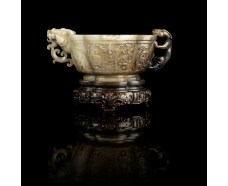 WHITE AND RUSSET JADE 'TAOTIE' CUP WITH DRAGON AND CHILONG HANDLES MING DYNASTY, 16TH-17TH CENTURY 明 白玉提油仿古饕餮紋倭角海棠式龍首杯 raised