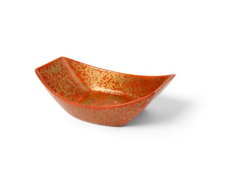 GILT-DECORATED CORAL-RED- GLAZED TEA BOAT QING DYNASTY, JIAQING MARK AND OF THE PERIOD 清嘉慶款及年代 珊瑚紅地描金纏枝蓮紋茶船 of boat form, the